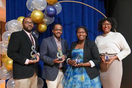 Recipients of the Black In STEM Award pose with their trophies.