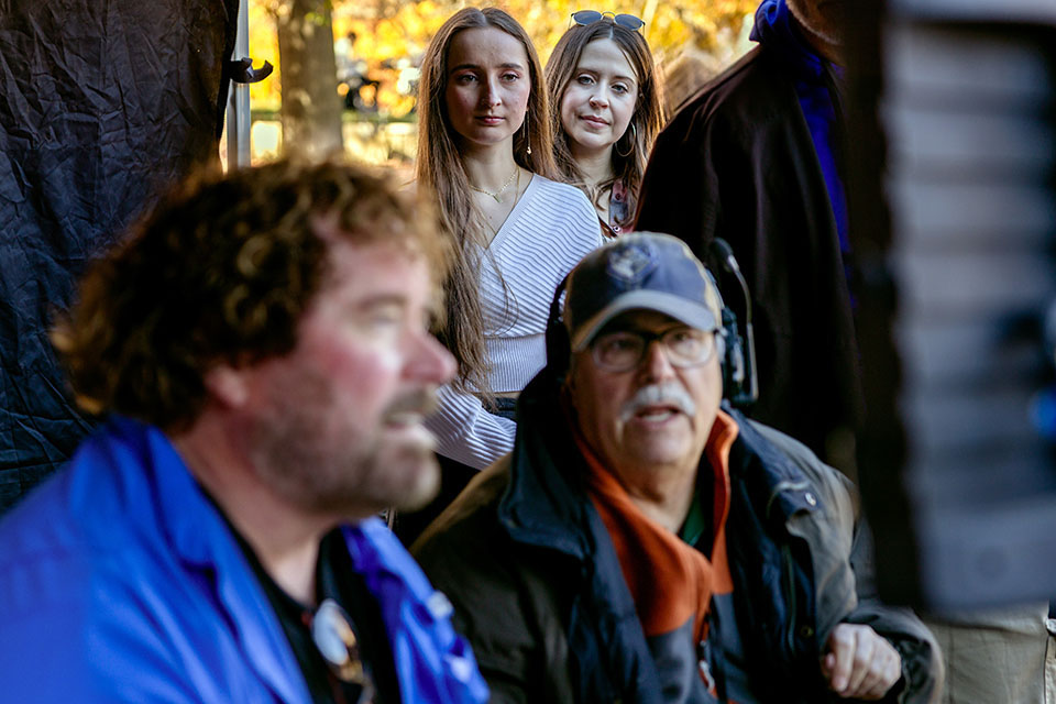 Sara Rae Womack, back right, and student Lauren Tubbe, watch director Sean McNamara, front left, during filming of “On Fire,” a movie based on alum John O’Leary’s life, on November 10, 2023.